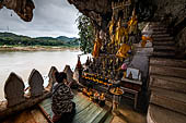 Luang Prabang, Laos - The Pak Ou Caves, the lower cave called Tham Ting. The caves, a Buddhist pilgrimage site, are a repository of old Buddha statues. 